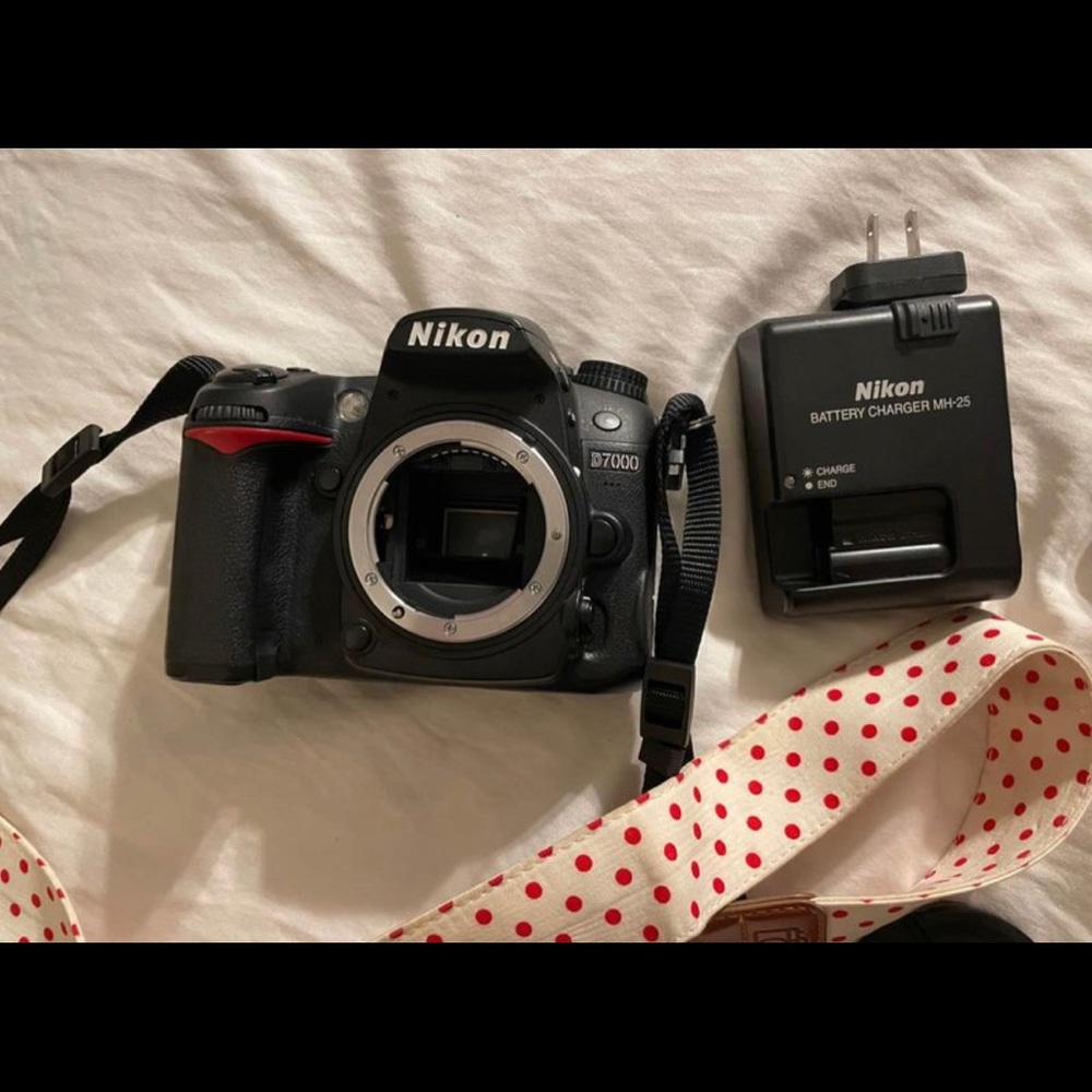 Nikon D7000 with 2 lenses, extra battery, and camera strap.